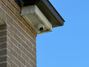 DH-IPC-HDW3667EM-S-IL-ANZ real installation - close-up of the white turret camera mounted beneath an eave; camera installation example, not the full kit contents